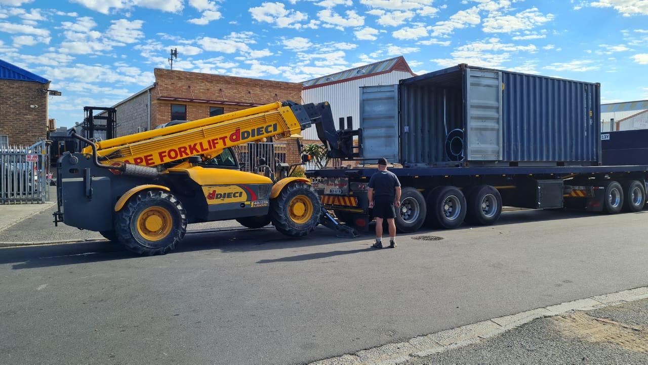 Telehandler loading a shipping container